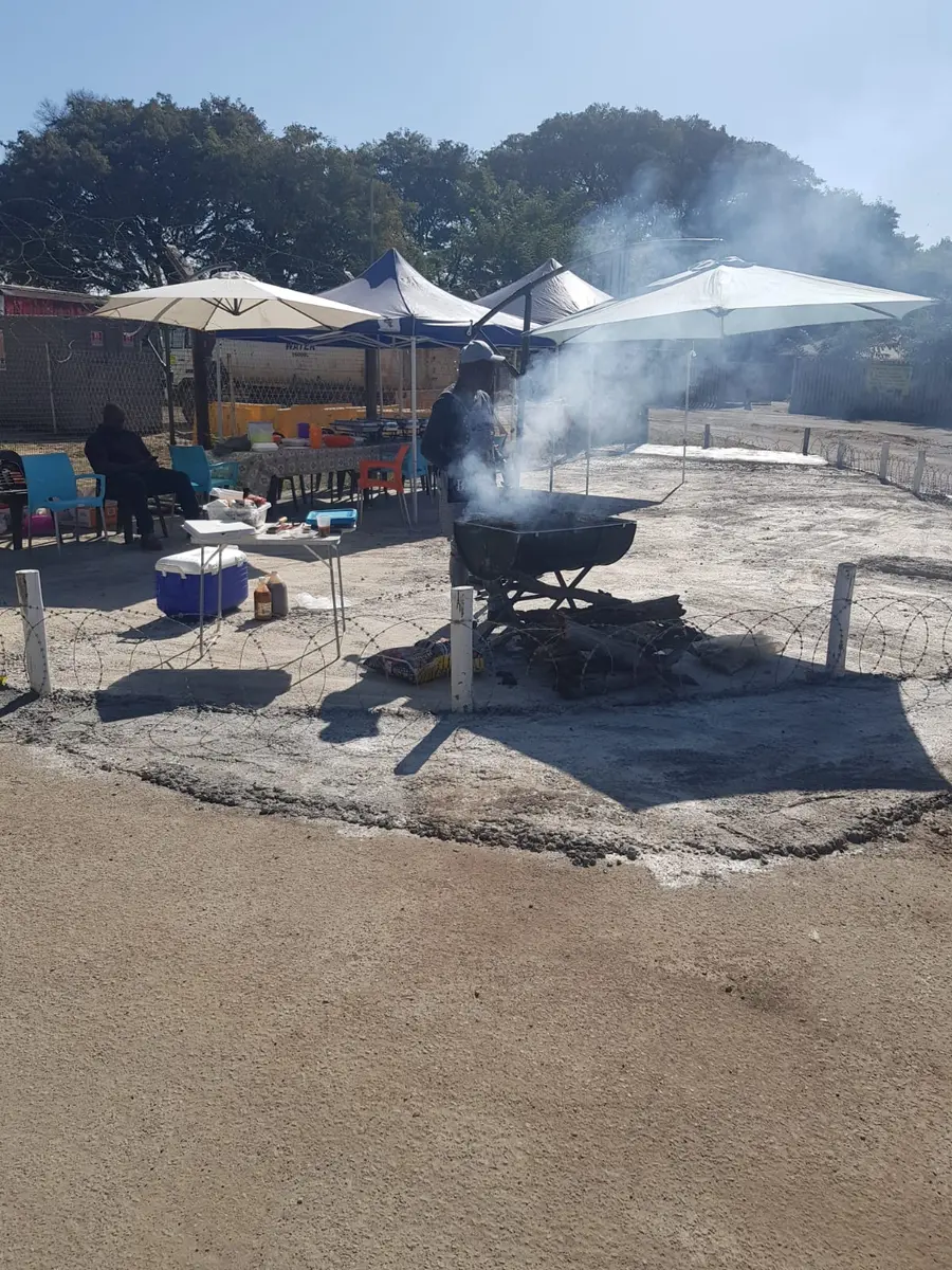 NTV team member grilling food on the braai for customers